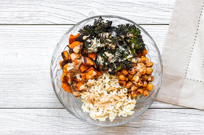 Overhead shot of the roasted sweet potato and broccoli rice bowl with a beige napkin.