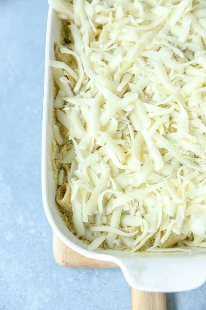 unbaked chicken pesto bake in a white casserole dish