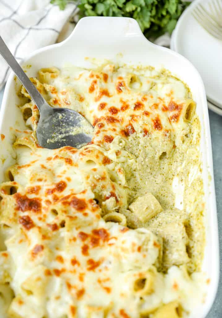 chicken pesto pasta bake in a white casserole dish