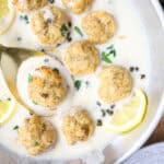 overhead photo of the chicken piccata meatballs in a stainless steel pan.