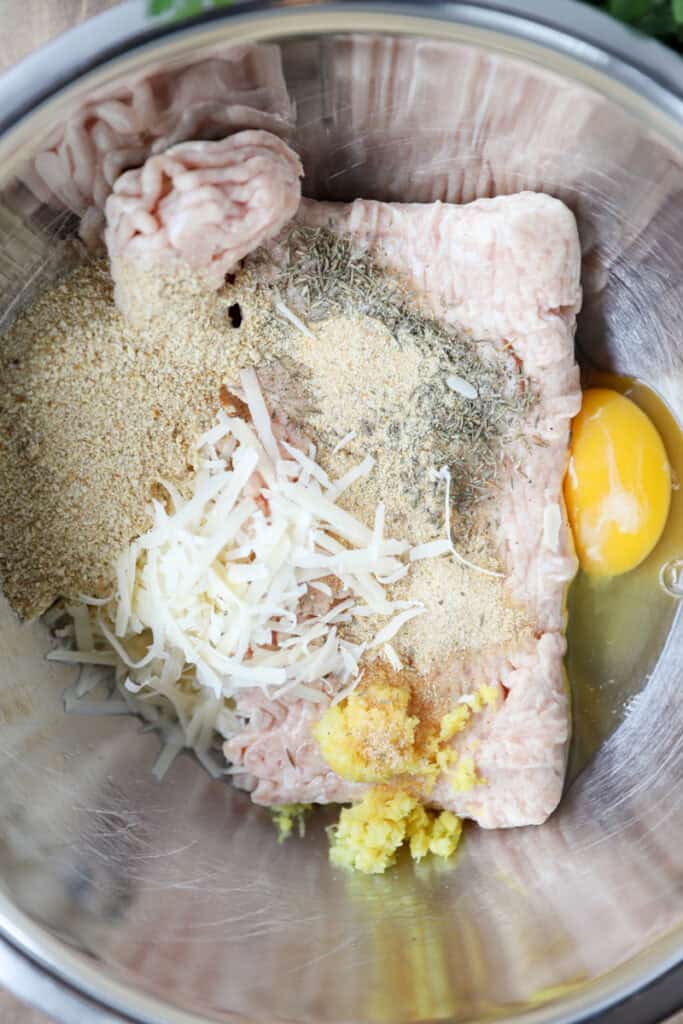 overhead photo of the meatball ingredients in a stainless steel bowl.