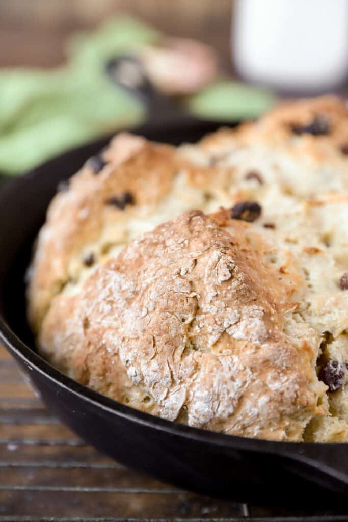 close photo of a corner of the baked bread in the cast iron skillet.