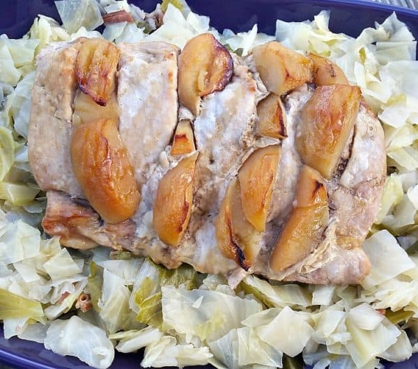 overhead shot of the apple stuffed pork tenderloin on a bed of cabbage.