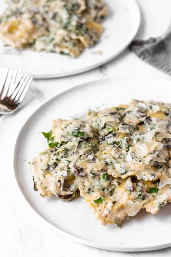 sherry cream sauce ravioli on a white plate.