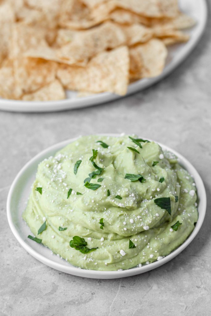 Close shot of the small plate with the dip sprinkled with parsley.