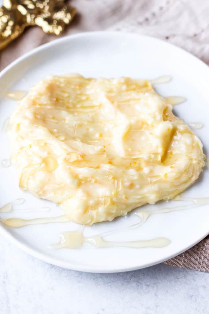 orange honey butter on a white plate