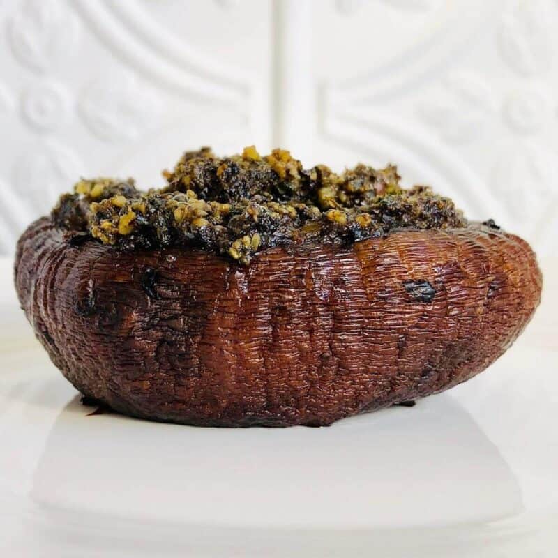 vegan stuffed Portobello mushrooms on a white dish