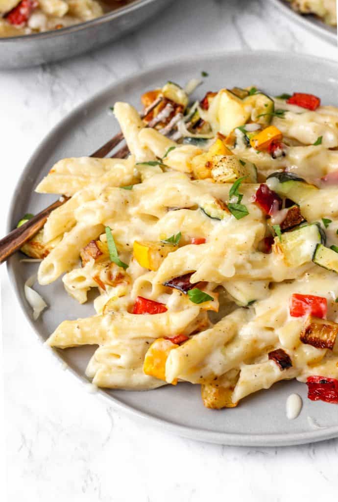 close view of the vegetable pasta dish on a grey plate