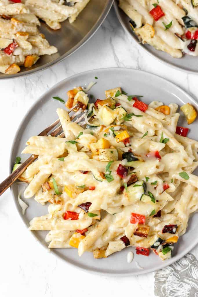 overhead view of the vegetable pasta on a grey round plate