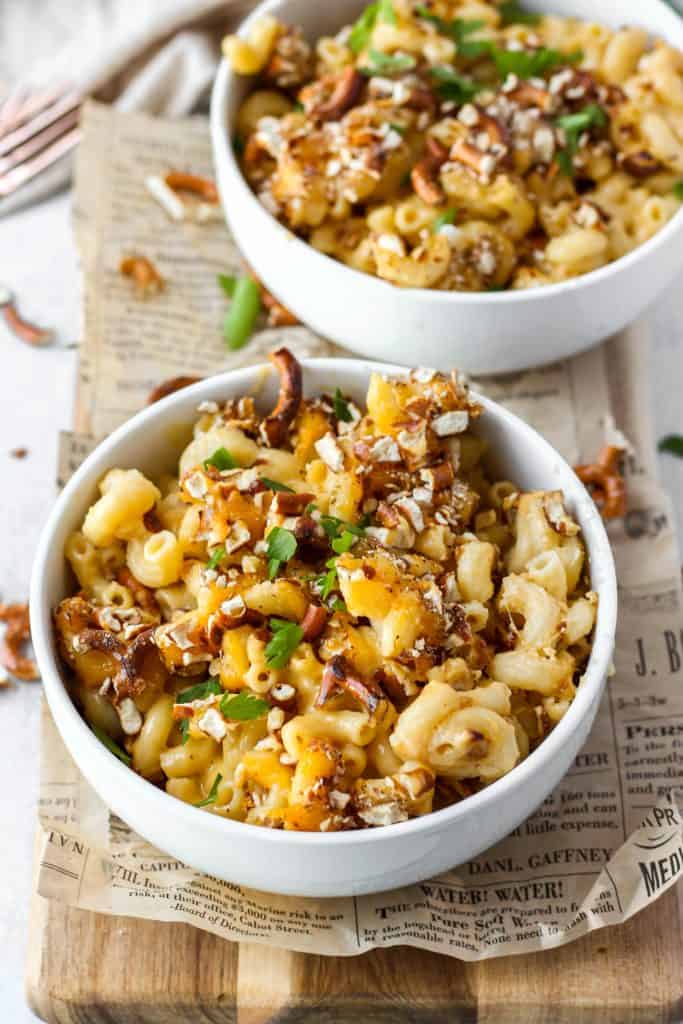 overhead shot of the mac and cheese in a bowl on a wood board