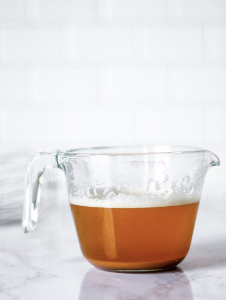 a glass measuring cup of brown butter