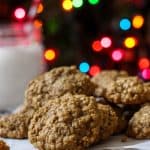brown butter oatmeal cookies on a silver tin with christmas lights behind