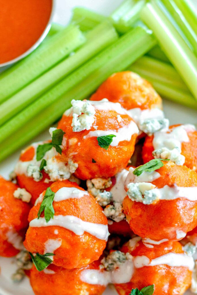 overhead shot of buffalo chicken meatballs with celery in the background.