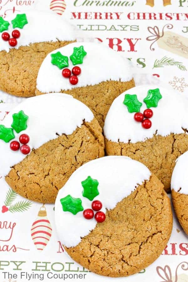 round gingerbread cookies with white frosting and holly decoration.