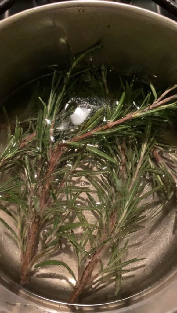 overhead shot of rosemary springs in the pot of sugar water.