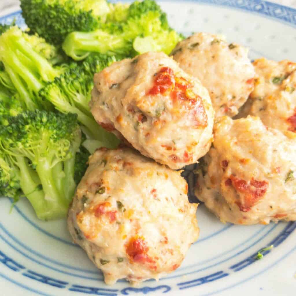 close shot of the chicken meatballs with broccoli. 
