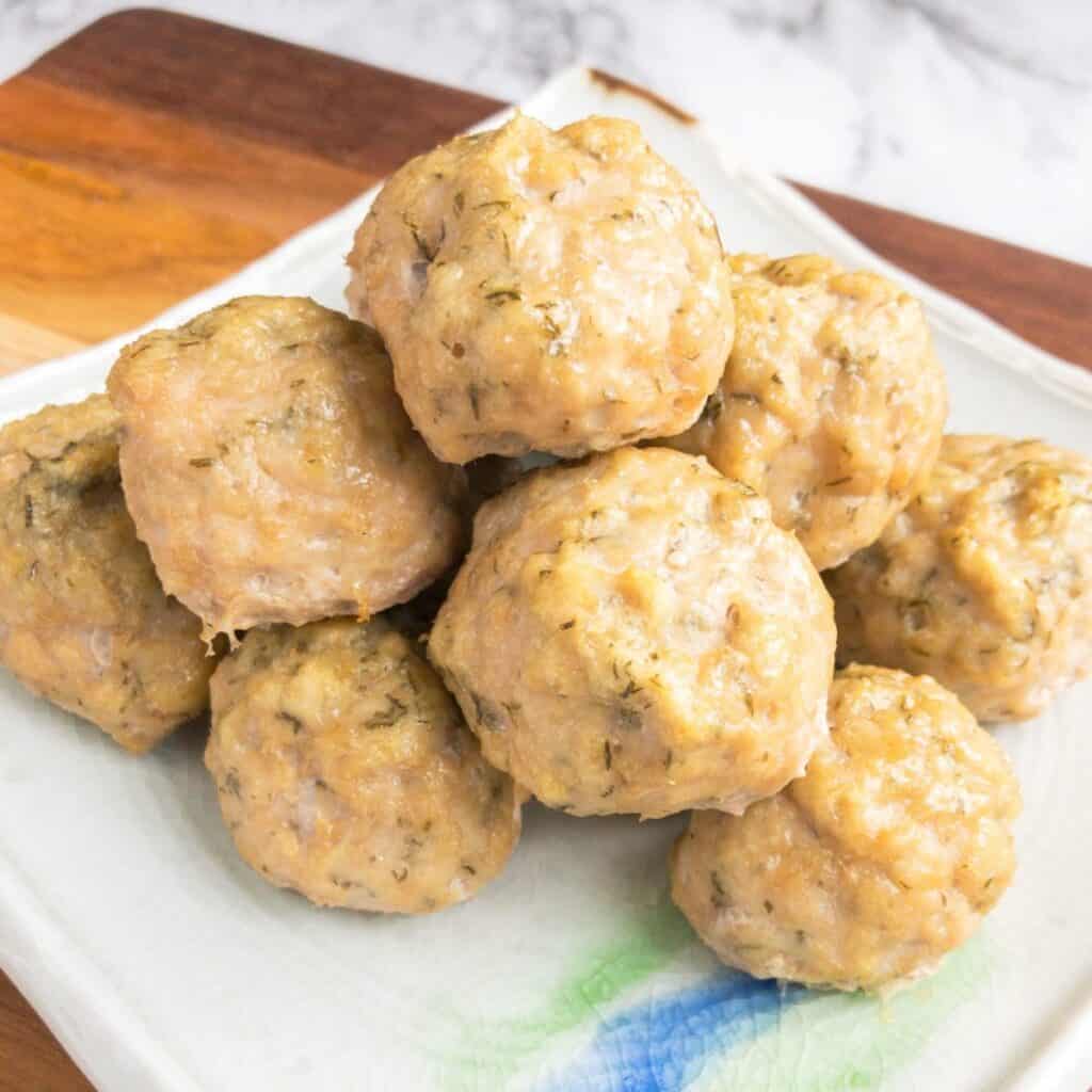 pile of the ranch chicken meatballs on a square plate.