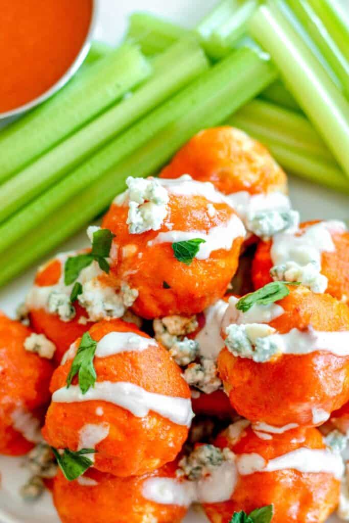 buffalo chicken meatballs with crumbled blue cheese and celery.