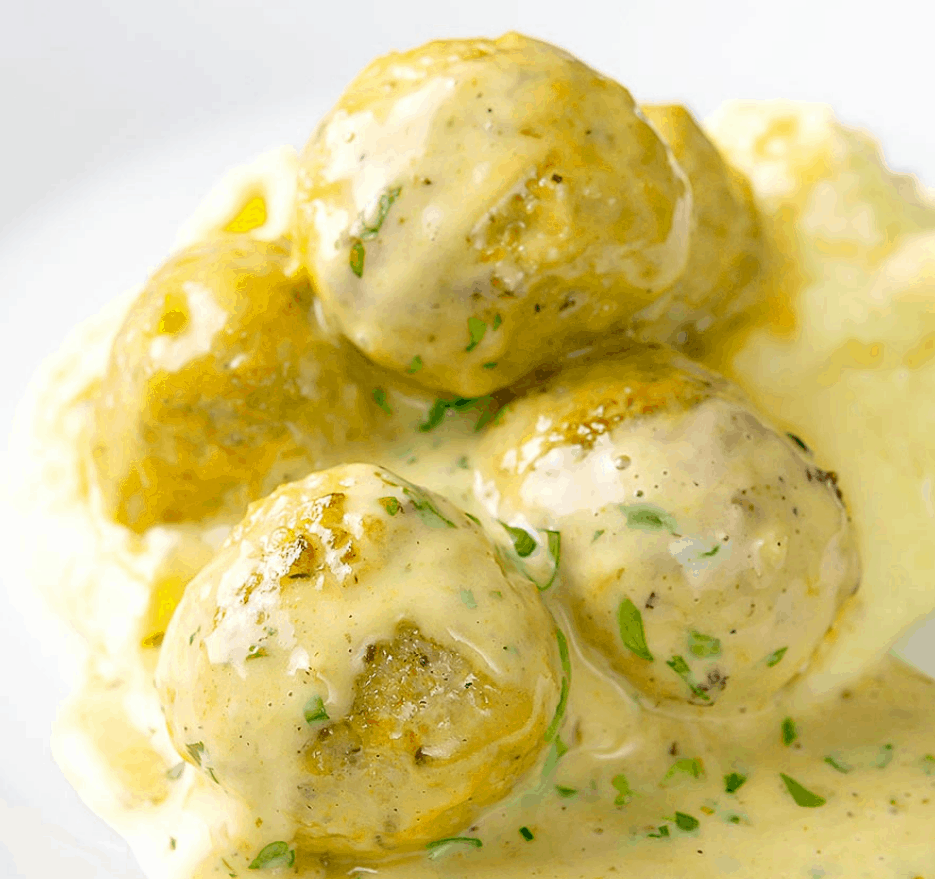 a pile of the chicken meatballs in a honey mustard sauce.