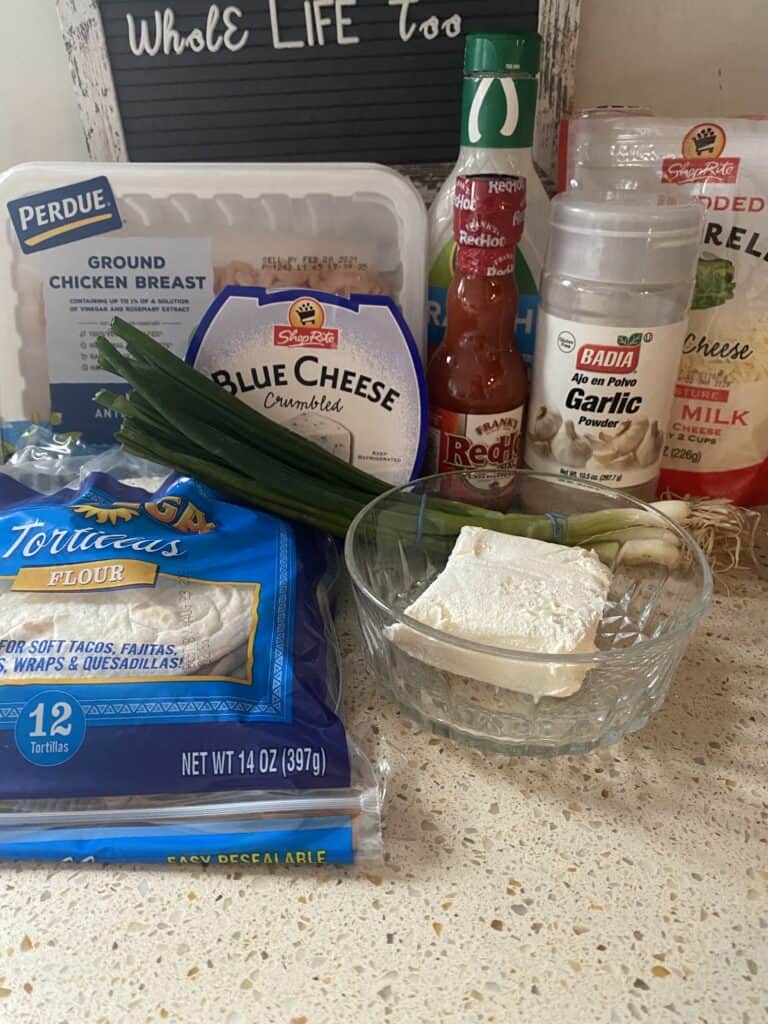 ingredients photo: ground chicken, tortillas, blue cheese, cream cheese, scallions, hot sauce, garlic powder, ranch, Mozzarella cheese.