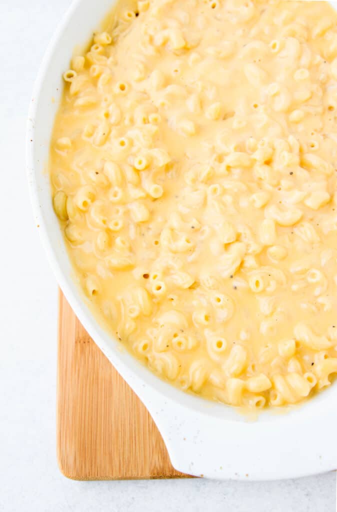 overhead shot of the mac and cheese in the white casserole dish without the topping before baking.