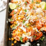 the Mexican street corn waffle fries on a baking tray with parsley in the back.