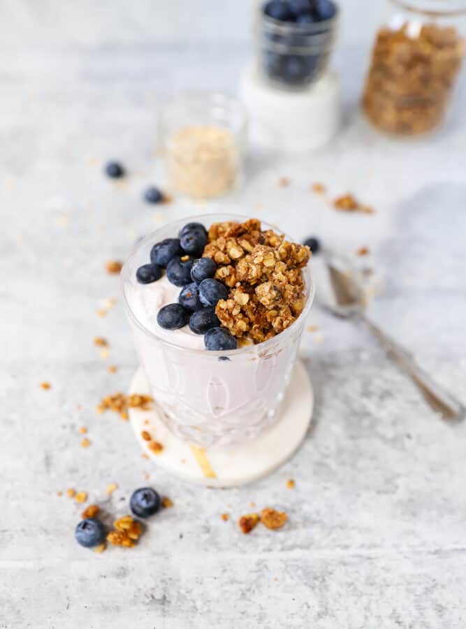 overhead shot of walnut granola in a glass with yogurt