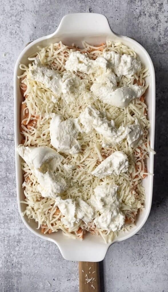 overhead shot of the penne vodka bake in the casserole dish now topped with the Mozzarella and Burrata.