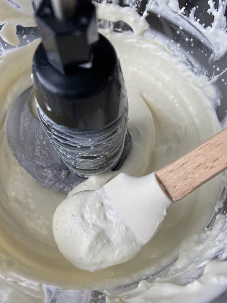 a small spatula showing the whipped feta texture.