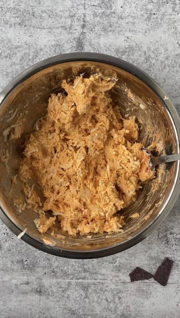 the dip mixture in a silver mixing bowl.