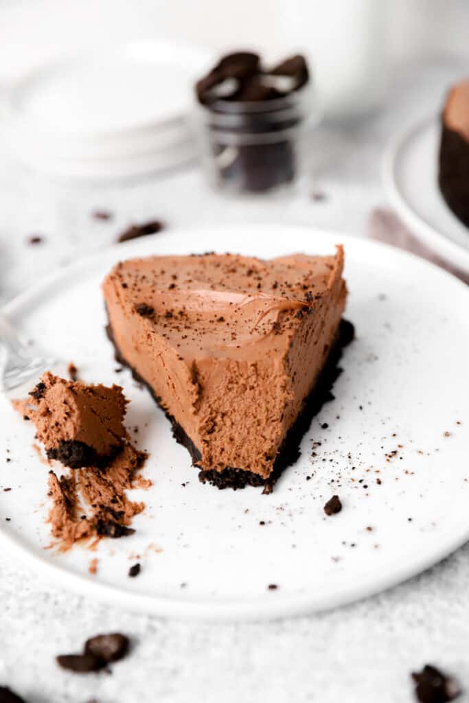 slice of no bake chocolate cheesecake on a white plate