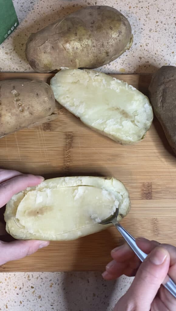 photo demonstrating scooping the potato from the skin.