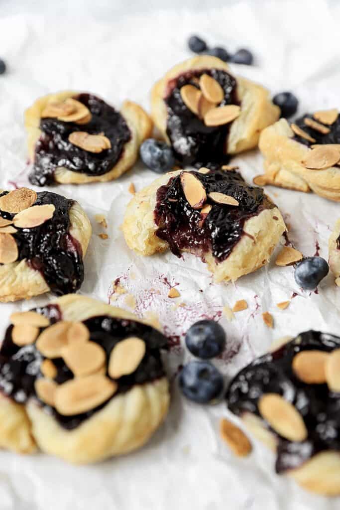 mini blueberry almond danishes on parchment paper.