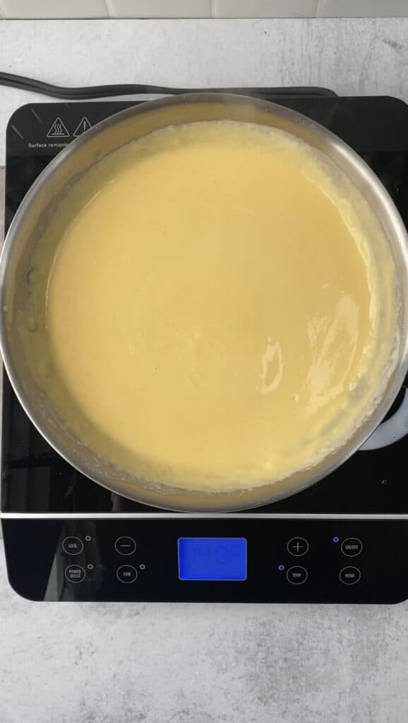 overhead shot of the cheese sauce in a stainless steel pan