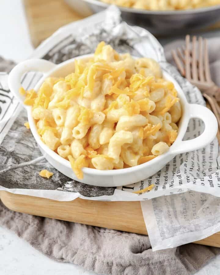stovetop mac and cheese in a white dish on newsprint paper.