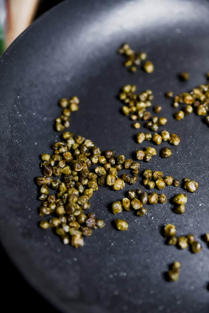 close shot of the fried capers in the pan.