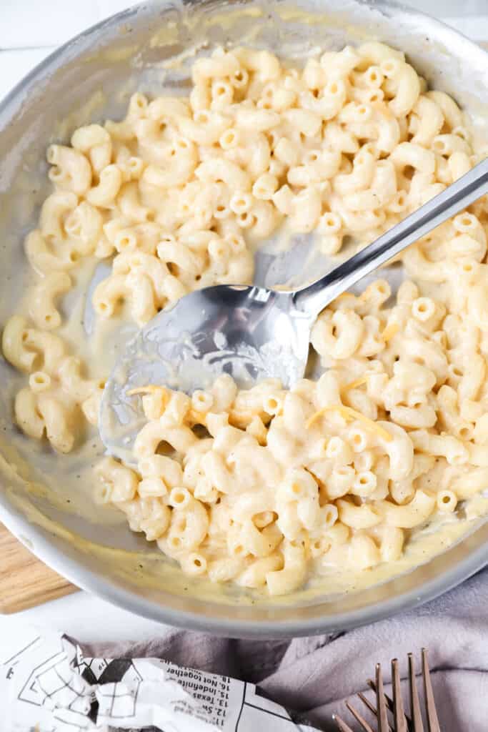 overhead shot of the adult mac and cheese in the pan with a silver spoon