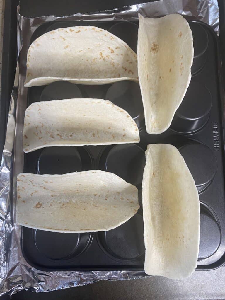overhead shot of the tortillas in the muffin pan.