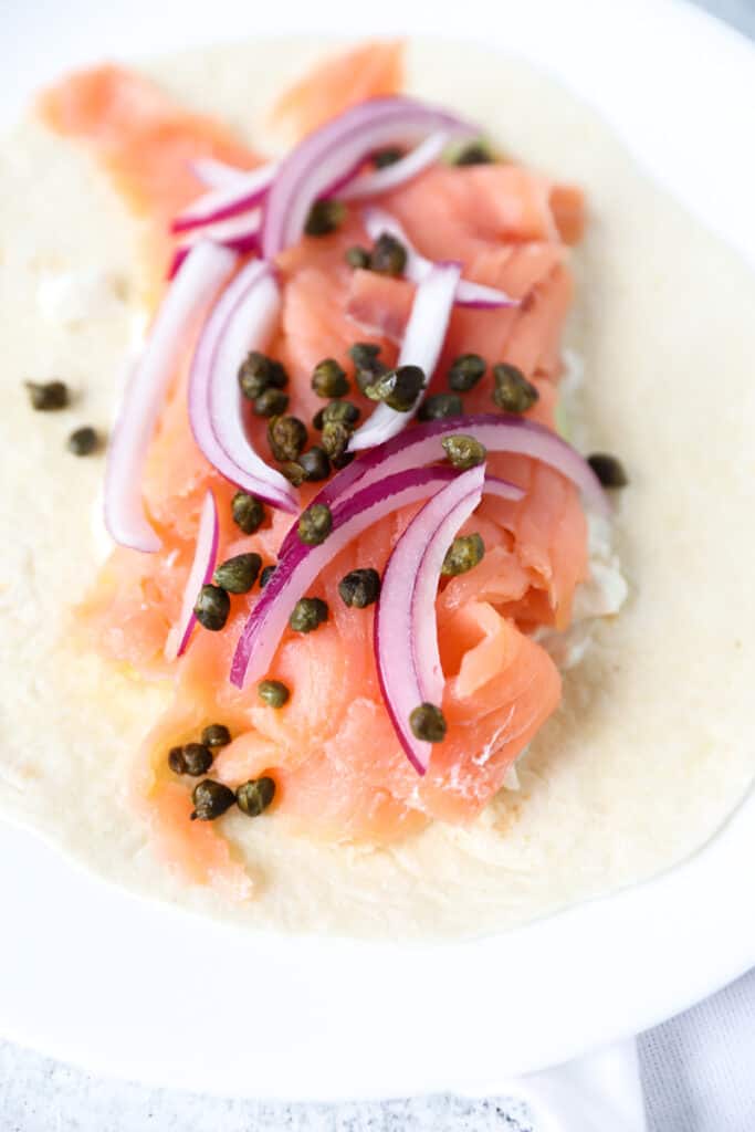 smoked salmon wrap topped with fried capers and red onions.