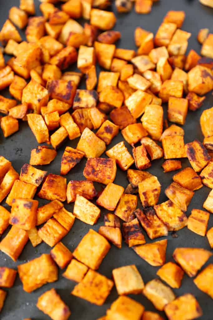 overhead shot of the sweet potato home fries on a baking sheet.