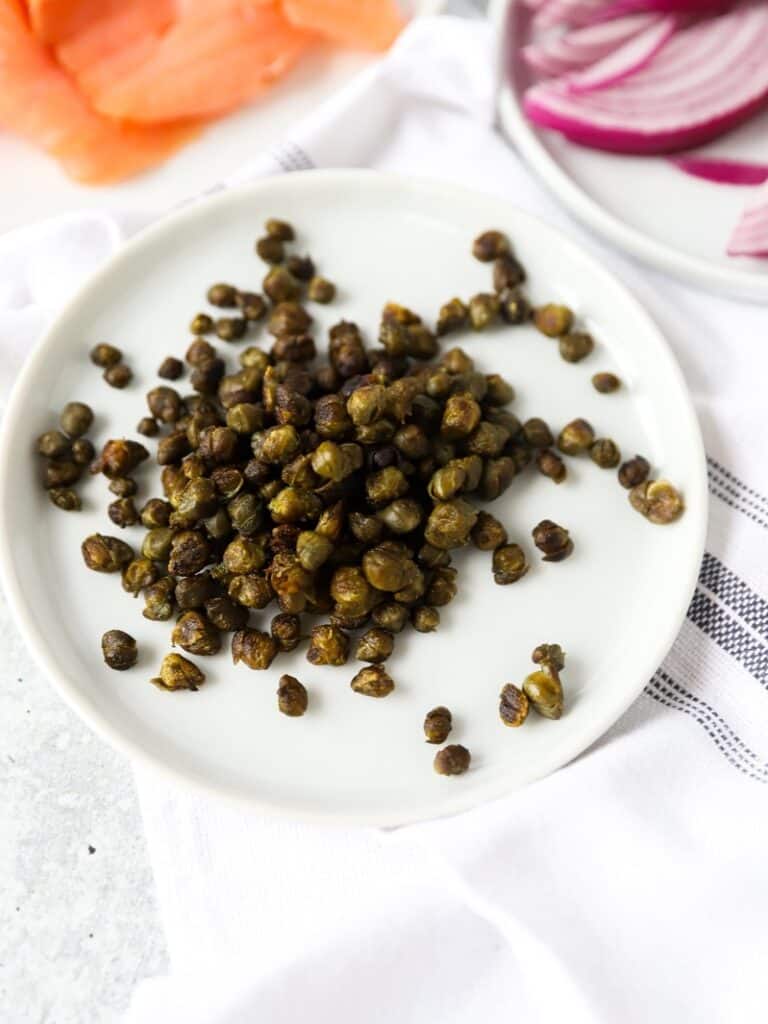 fried capers on a white round plate