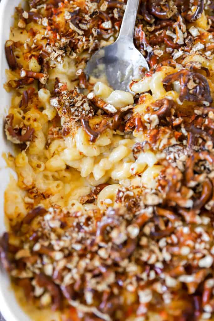 close photo of the baked mac and cheese with a large silver serving spoon.