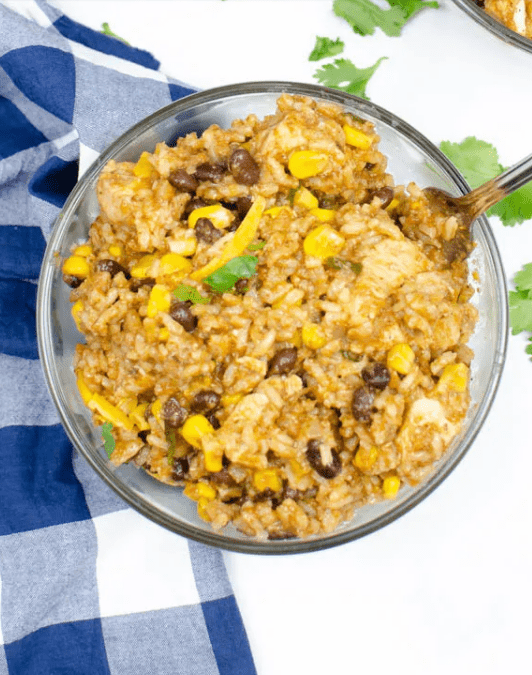 overhead shot of chicken burrito bowl with a blue plaid napkin