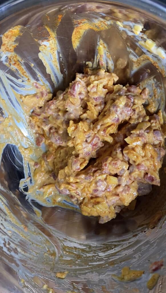 overhead shot of the pimento cheese spread in a silver mixing bowl.