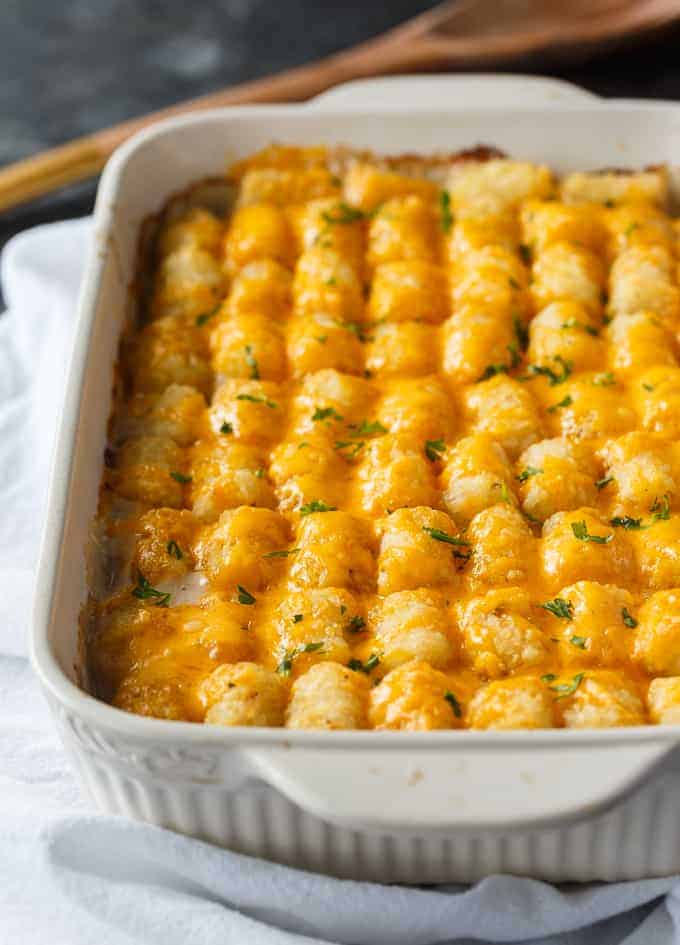 tator tot casserole in a white baking dish.