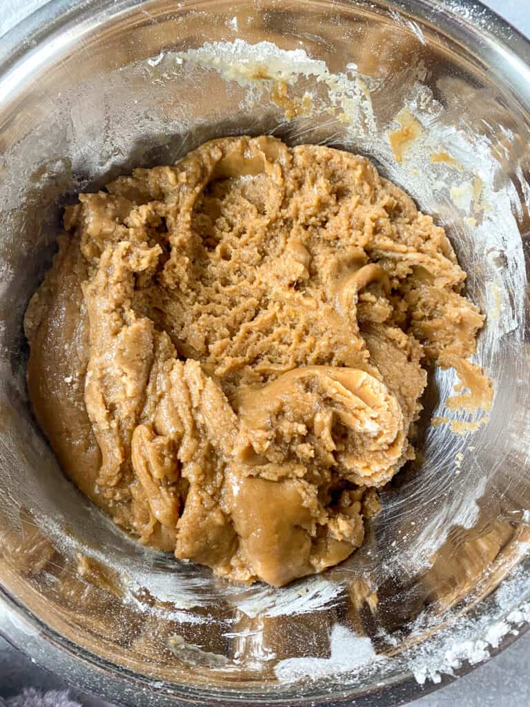 overhead shot of of the cookie dough in a silver mixing bowl.