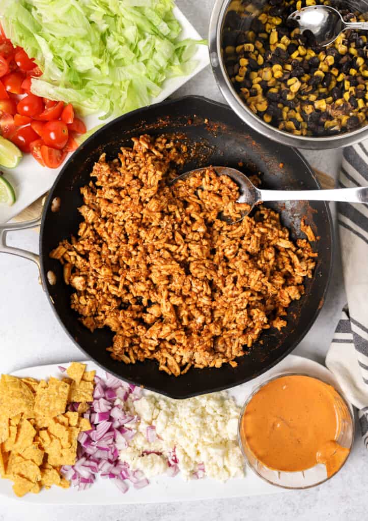 overhead shot of the cooked ground chicken in the black nonstick pan.