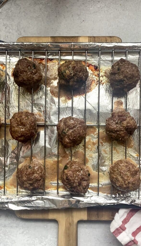 the cooked meatballs on the baking sheet.