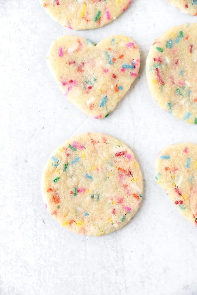 overhead shot of a circle and heart shaped cookie after baking.