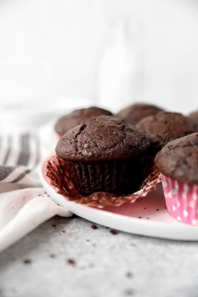 espresso muffin with the pink wrapper peeled back on a large white plate